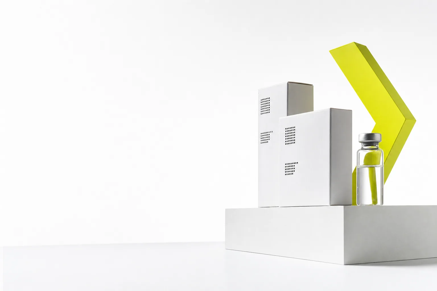 Pharmaceutical cartons and a citron chevron on white sculptural steps